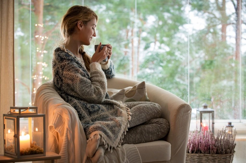 young woman sitting home by the window picture id882116488